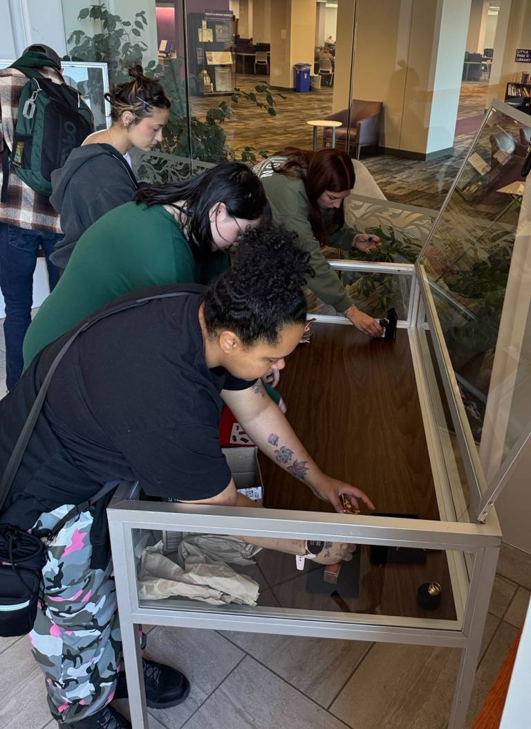 metalsmithing students installing work at hale library spring 26